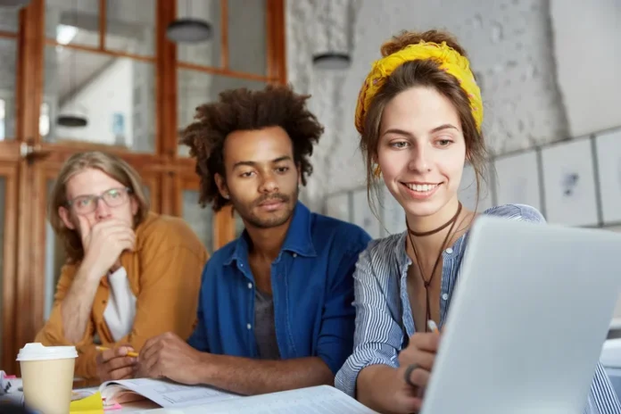 colleagues-working-together-while-sitting-cafe