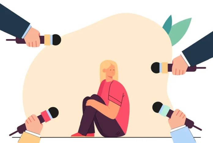 Girl-sitting-on-floor-surrounded-by-hands-holding-microphones